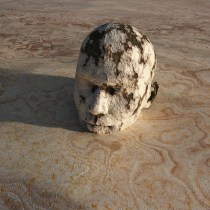 Man stuck in sand up to his head